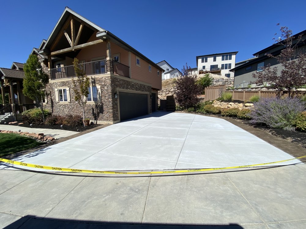 Finished concrete driveway at a stone home in Pleasant Grove, UT