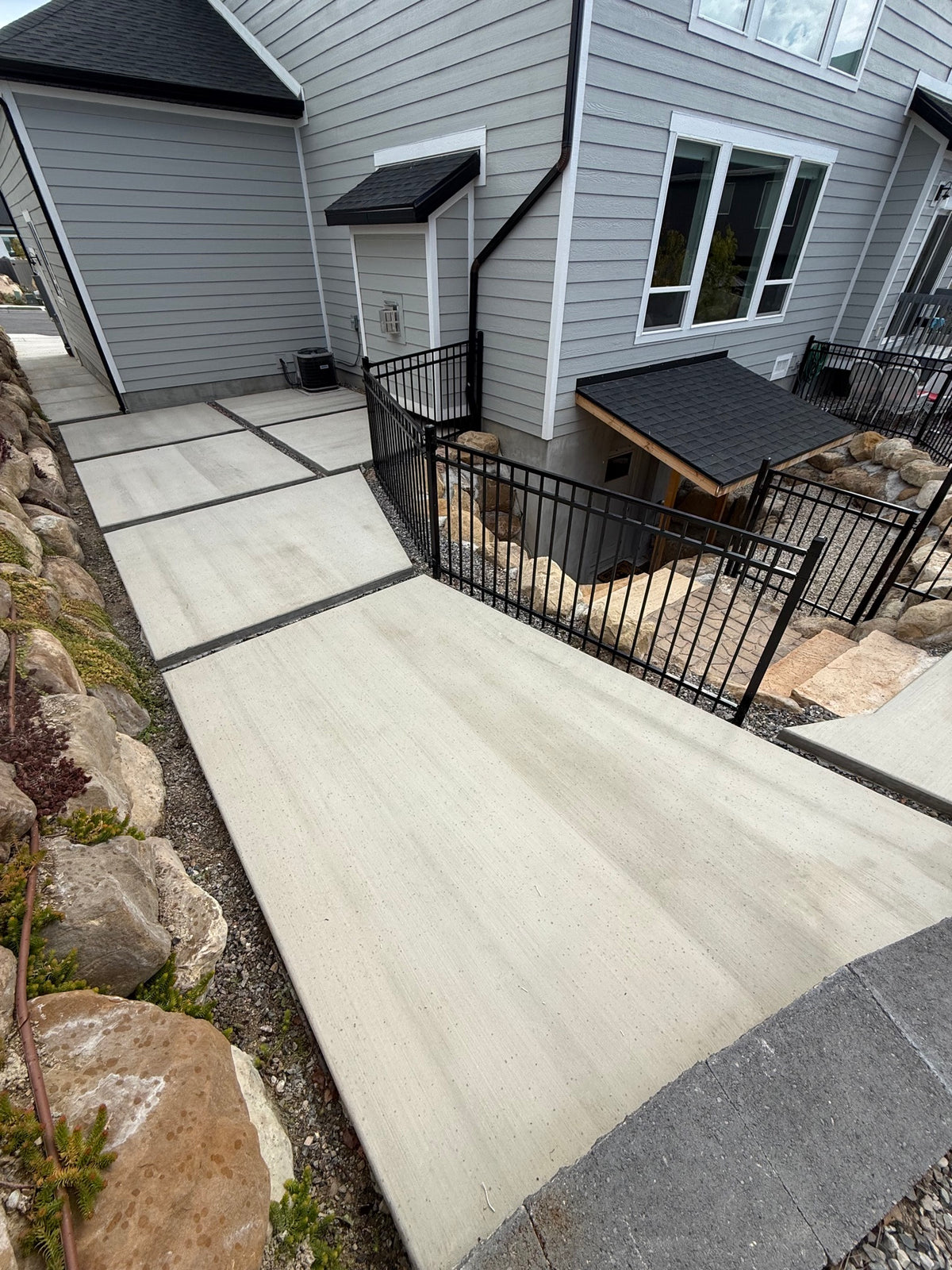 Broom-finish concrete side-yard walkway running between two homes in Lehi, UT